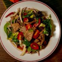 Beef Salad · Spicy. Sliced charcoal grilled tenderloin on a bed of lettuce, bell pepper, mushrooms, red o...
