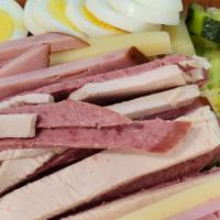 Julienne Salad Bowl · Tossed crisp greens with julienne of turkey, salami, ham, Swiss cheese, and hard boiled eggs.