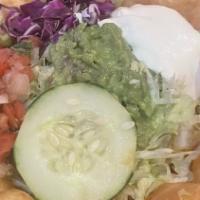 Taco Salad · Filled with rice and beans and topped with cheese, lettuce, sour cream, tomatoes and guacamo...
