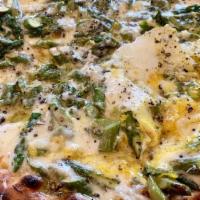 Asparagus Pizza · Asparagus, lemon, caramelized onions, garlic crema, fontina, ricotta and parmesan
