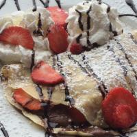 Strawberry Nutella · Nutella filled crepe with strawberries, and whipped cream on the side