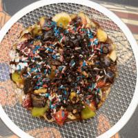 Belgian Waffle · Plate or sandwich. Waffle served with chocolate, 2 fruits, sauce, powder sugar, and sprinkles.