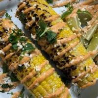 Grilled Elote · Grilled corn topped with chipotle mayo, cotija cheese, cilantro, lime