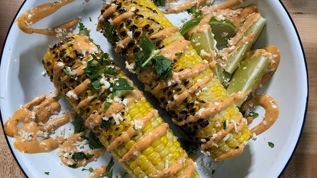 Grilled Elote · Grilled corn topped with chipotle mayo, cotija cheese, cilantro, lime