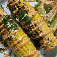 Vegan Grilled Elote · Grilled corn topped with vegan chipotle mayo, cilantro, lime