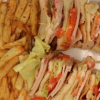 Turkey & Bacon Club · Sliced turkey with bacon, lettuce, and tomato on bread.