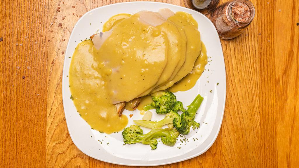 Roast Turkey · Young slow roasted turkey breast over stuffing and topped with turkey gravy. Served with two sides of your choice.