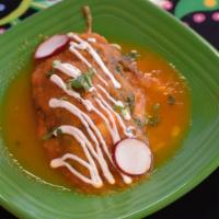 Chile Relleno · One egg battered poblano pepper stuffed with cheese. Topped with traditional red salsa, driz...