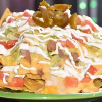 Beantown Nachos · Includes choice of filling. Yellow corn chips topped with refried beans, nacho cheese, lettu...