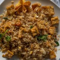 Pineapple Fried Rice · Stir-fried rice with egg, onions, scallions, pineapple, roasted cashews, and raisins garnish...