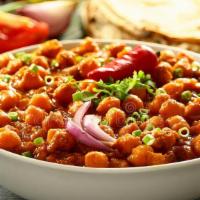Chana Saag With Rice (V) · Vegan, gluten-free. Garbanzo beans simmered in a tomato-onion gravy and flavored with spices.