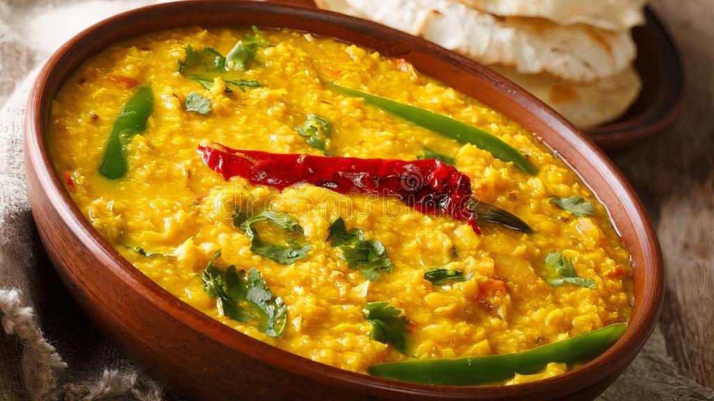 Daal Tadka (V) · Vegan, gluten-free. Yellow lentil tempered with Indian spices and tomatoes, Indian herbs and spices.