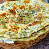 Aloo Kulcha · Made with all-purpose white flour. Naan bread filled with mildly spiced tomatoes.