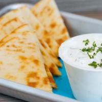Pita And Dip · Your choice of tzatziki, hummus, or spicy feta dip with toasted pita.
