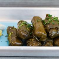 Dolmades · Grape leaves stuffed with rice and authentic Greek spices.