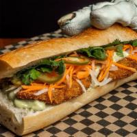 Fried Chicken Banh Mi · Seasoned soy fried chicken, french baguette, cilantro aioli, pickled carrots, daikon, & jala...