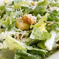 Caesar Salad · Romaine lettuce, shaved Parmesan cheese, garlic croutons, Caesar dressing.