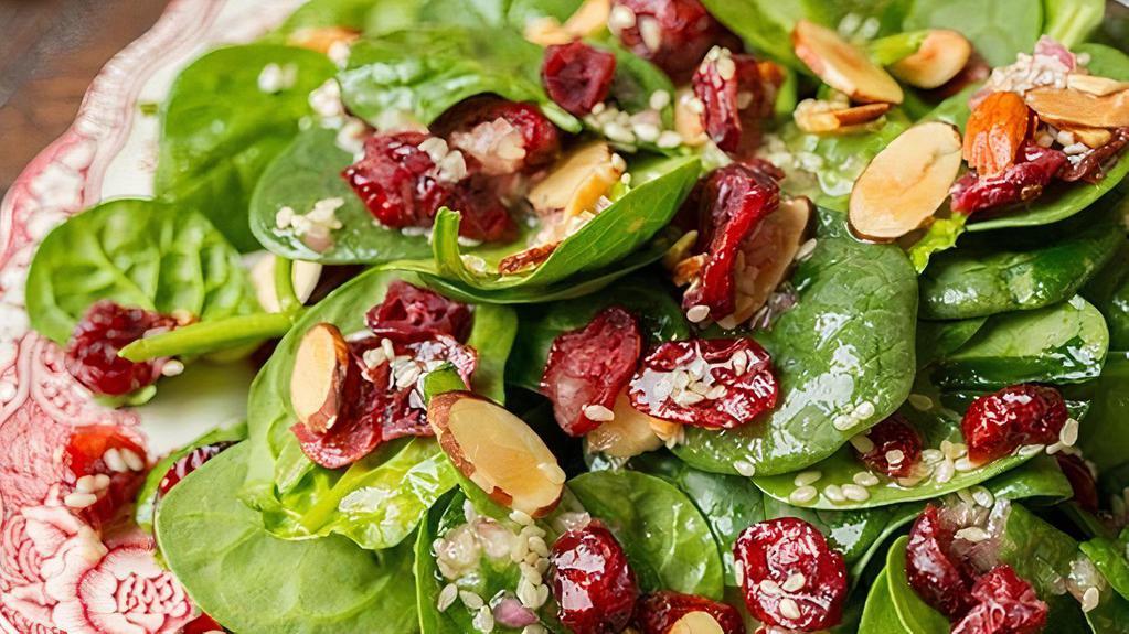 Spinach Salad · Baby spinach, goat cheese, sliced almonds, dried cranberries, pears, poppy seed dressing.