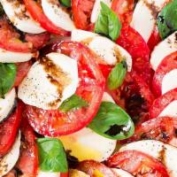 Caprese Salad · Green leaf lettuce, fresh mozzarella cheese, tomatoes, basil leaves, roasted red peppers, ol...