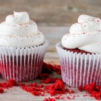 Red Velvet Cupcake · Red velvet cake with cream cheese frosting and red crumbs on top.