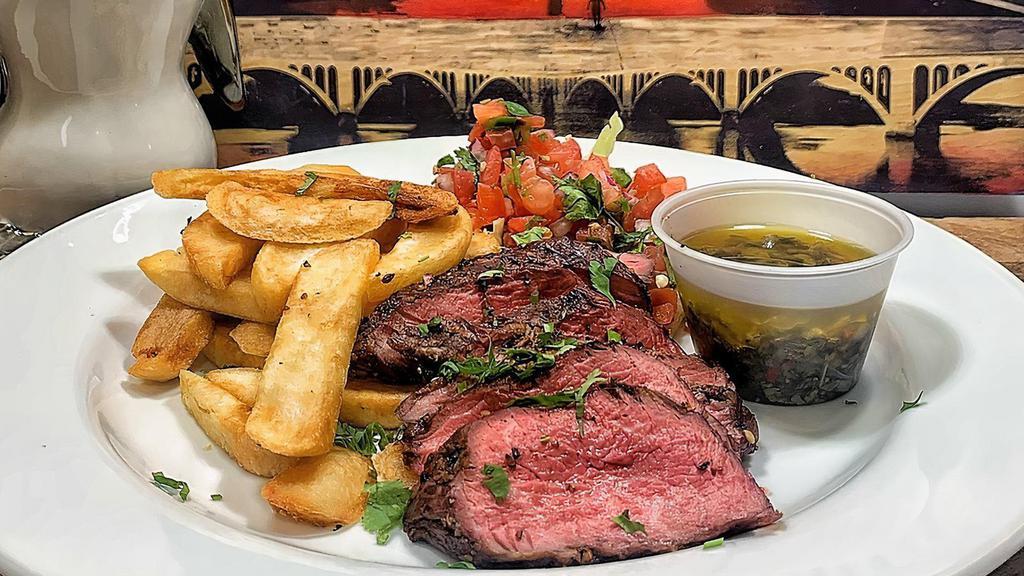 Steak Chimichurri  (Available Everyday!) · Char grilled steak, sliced and served with steak fries, salad & the classic,
Brazilian garlic-herb sauce.