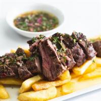 Steak Chimichurri  · Char grilled steak, sliced and served with steak fries, salad & the classic, Brazilian garli...