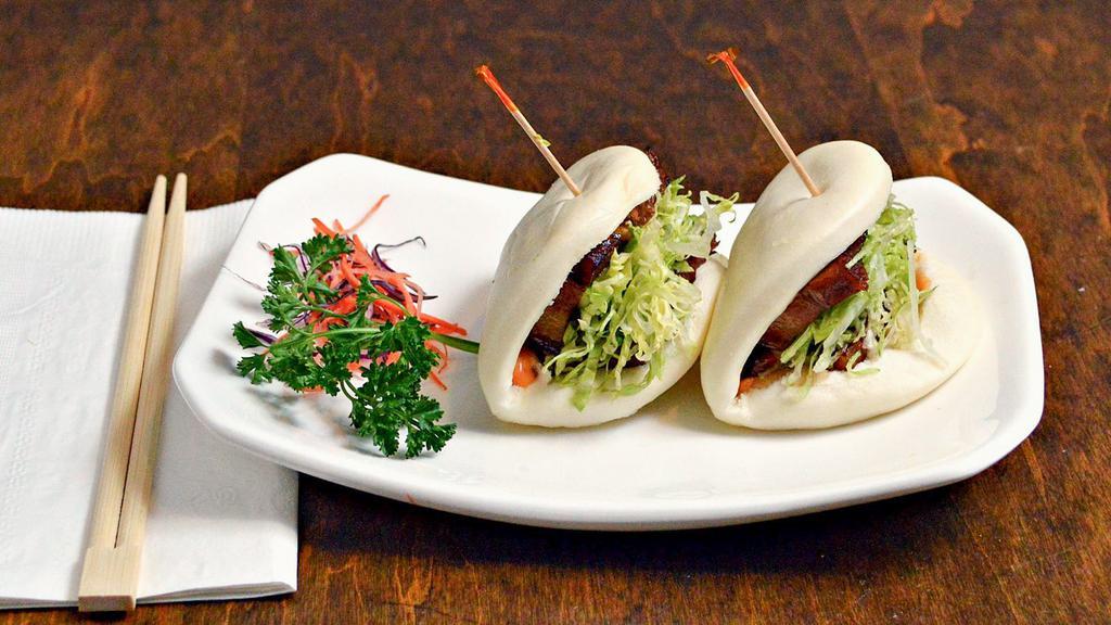 Pork Belly Buns · Steamed bun filled with pork belly chashu and lettuce, served with spicy mayo .