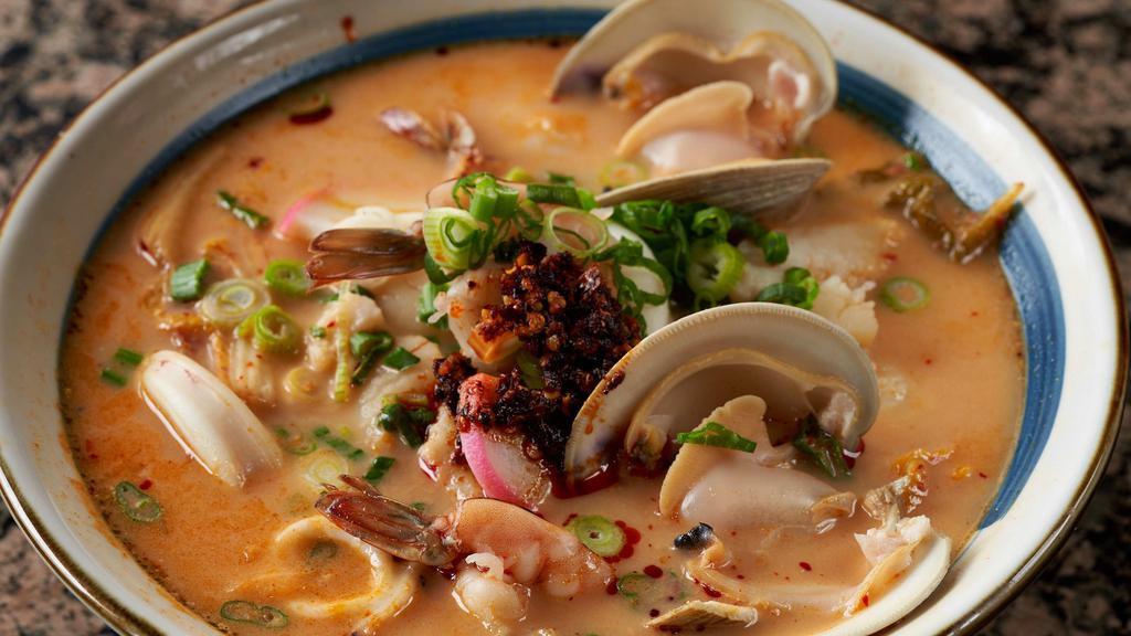 Spicy Kimchi Seafood Ramen · Rich chicken and pork soup base topped with assorted seafood, spicy kimchi and greens
