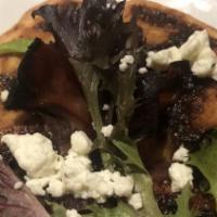 Fig And Pig · Caramelized onion, fig marmalade, prosciutto, topped with goat cheese and baby greens