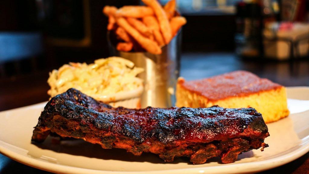 Baby Back Ribs · Slow cooked and smothered with drake's bbq sauce, served with French fries, Corn on the Cob and cornbread.
