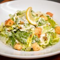 Ensalada Romana · Romaine hearts, croutons, olive-citrus tapenade with our homemade Caesar dressing.