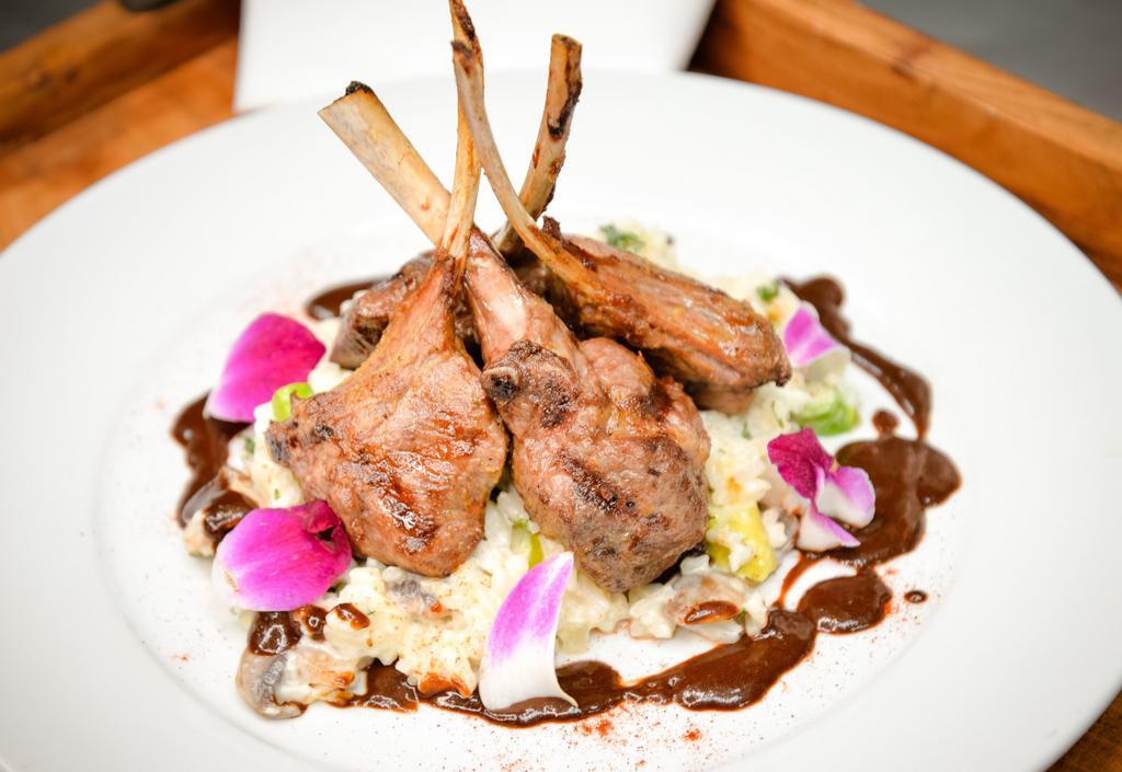 Borrego · Grilled lamb chops, risotto with asparagus, mushrooms. Artichokes and parmesan cheese, topped with A red wine reduction sauce.