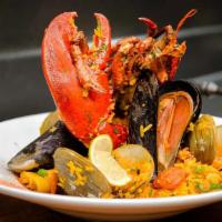 Paella Valenciana · Saffron broth, rice, whole lobster, chicken, shrimp, squid, octopus, mussels, cuban sausage ...