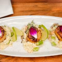 Scallops · Pan seared scallops over risotto with asparagus, mushrooms, artichokes and parmesan cheese.