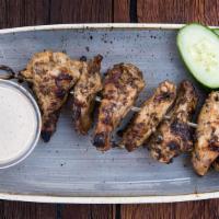 Smoked And Grilled Chicken Wings · 1 lb. HABF, hickory and applewood smoked, Alabama white sauce and cucumber. Gluten free.