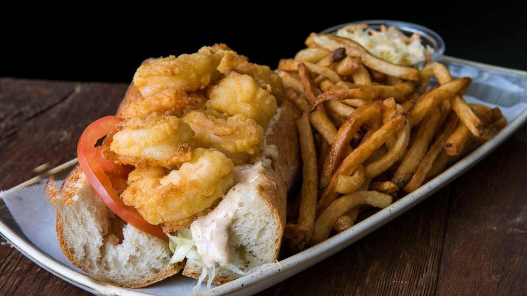 Fried Shrimp Po' Boy Sandwich · Shredded lettuce, tomato, pickle, roasted red peppers and spicy remoulade. Hand Cut French Fries, Cole Slaw