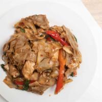 Drunken Noodles · Wide rice noodles stir-fried with tomato, onion, bell pepper, and basil leaves in a chili ga...