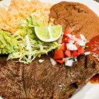 Carne Asada Plate · Rice, refried beans, salsa, pico, lettuce, guacamole, and tortillas.