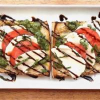 Bunker Hill Tost · Fresh Warmed Mozzarella, Pesto, with Basil Leaves, Tomato & Balsamic drizzle