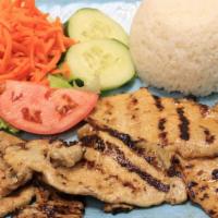 73 - Grilled Pork Chop Broken Rice · Broken rice, lettuce, cucumber, tomatoes, pickled carrots, and sautéed scallions.