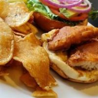 California Fried Fish Sandwich · Deep fried beer battered haddock fish, avocado, lettuce, tomato and dill tartar sauce on a b...