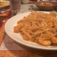Pad Thai Shrimp · Stir fried rice noodles with shrimp, with tofu, Thai basil, crushed peanuts, bean sprouts, s...