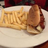 Grilled Texas Tommy · Frankfurter stuffed with cheese and rolled in bacon strips, fries.