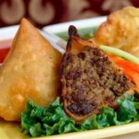 Meat Samosas · Pastry stuffed with ground beef, peas, herbs and spices.
