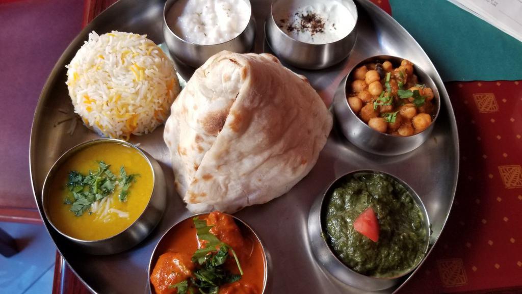 Lovash Non-Vegetarian Thali · With Mulligatawny Soup, Choice of meats (Chicken, Fish, Beef or Lamb), Palak Paneer, Chana Masala, Naan or Roti, Rice, Raita & Rice Pudding