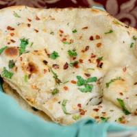 Garlic Naan · Topped with garlic, herbs and spices.