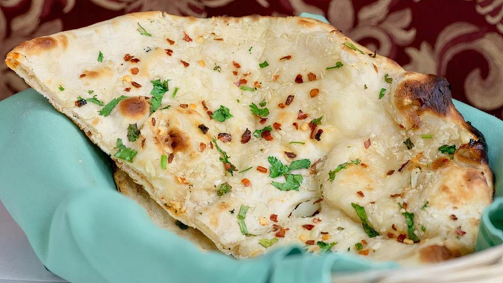 Garlic Naan · Topped with garlic, herbs and spices.