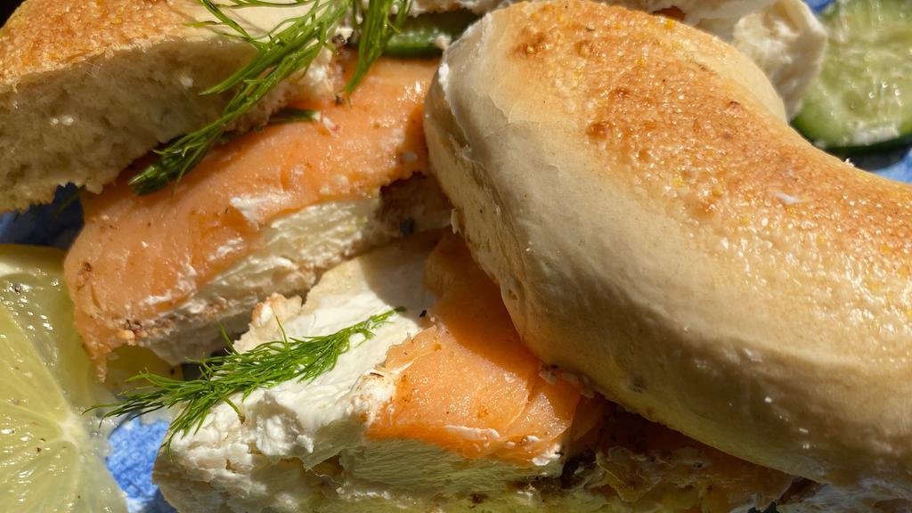 Smoked Salmon Bagel · Plain or Everything Bagel topped with cream cheese & smoked salmon, garnished with cucumber slices & fresh dill.