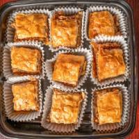 Baklava · Walnuts in layers of phyllo dough topped with honey syrup.
