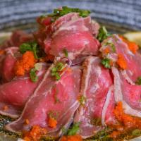 Beef Tataki · Thinly sliced rare beef with scallions and spicy grated daikon radish with ponzu sauce.